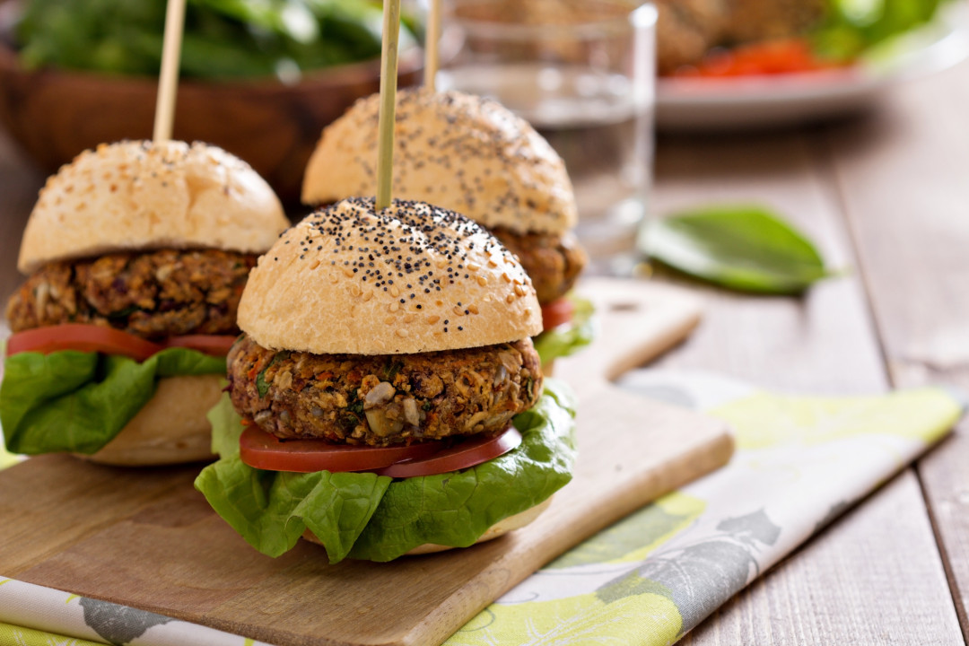 Vegan burgers with  beans and vegetables on a cutting board